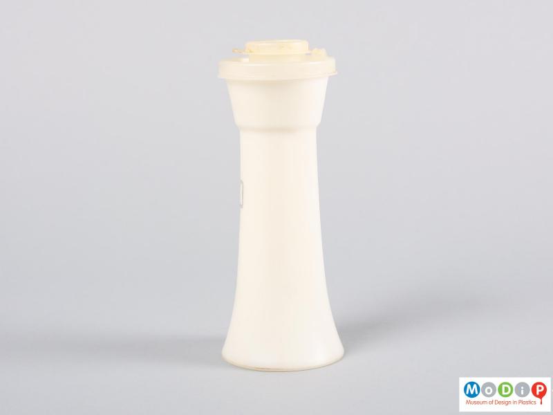 Side view of a pepper shaker showing the fluted shape.