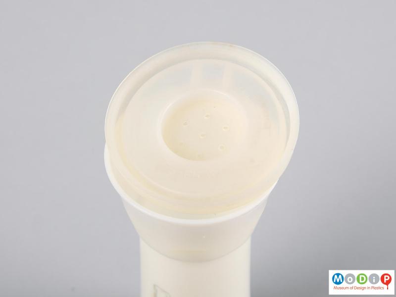 Top view of a salt shaker showing the underside of the lid.