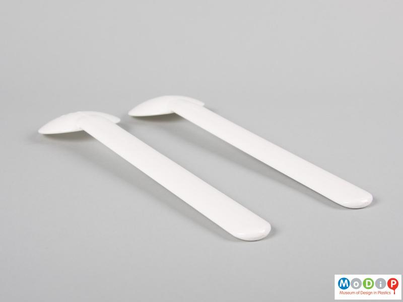 Side view of a set of salad servers showing the depth of the bowls.