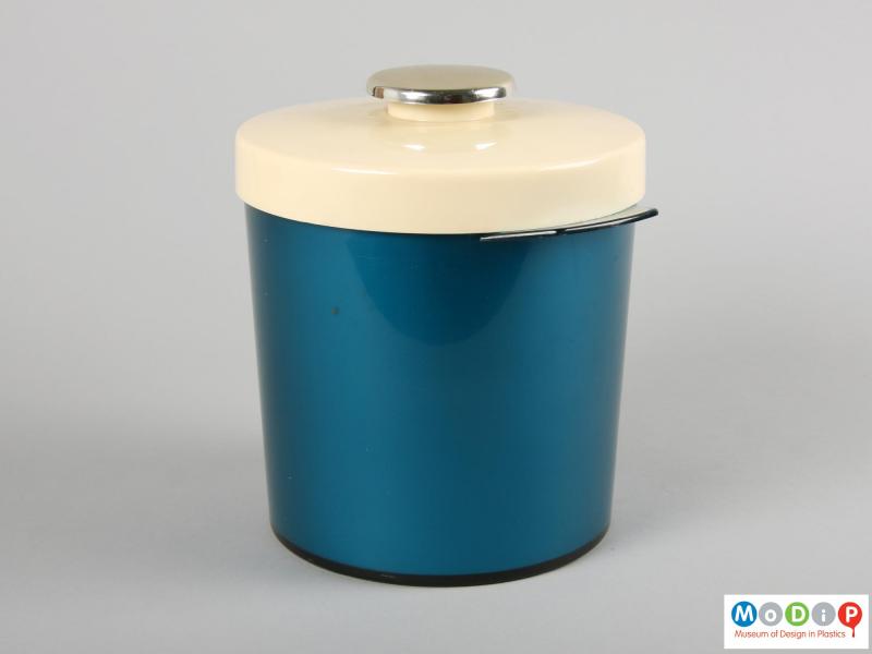Side view of an ice bucket showing the round knob on the lid.