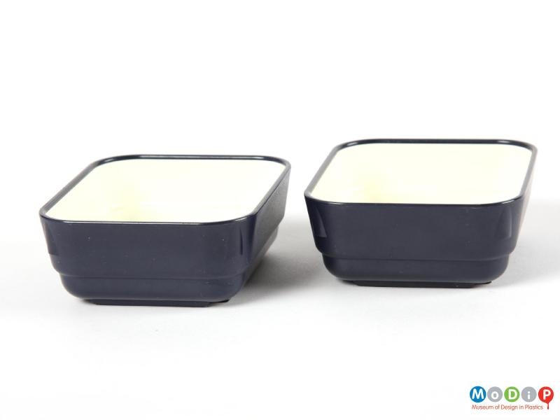 Side view of a pair of Caledonian Airways bowls showing the short ends.