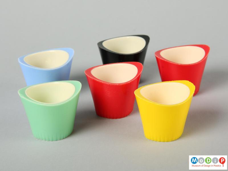 Side view of six Paramount egg cups showing the oval shape and the raised sides of the egg cup.