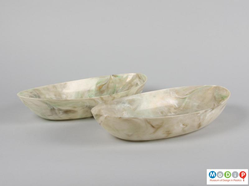 Side view of a pair of oval fruit bowls showing the straight sides.