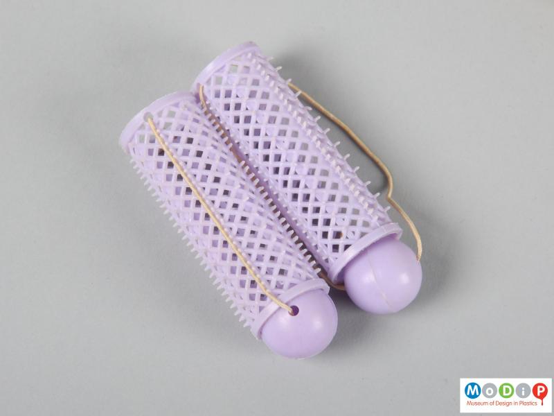 Side view of a set of curlers showing 2 purple curlers.