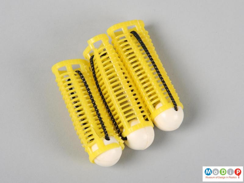Side view of a set of curlers showing 3 yellow curlers.