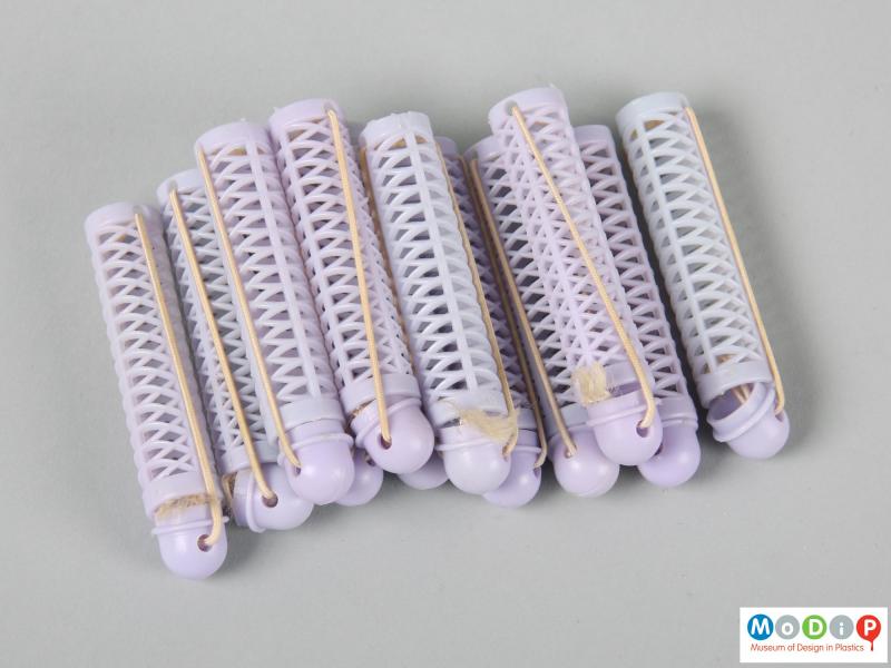 Side view of a set of curlers showing 12 purple curlers.