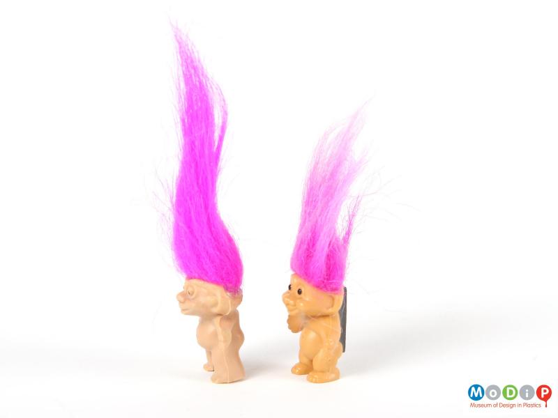 Side view of 2 trolls showing the rounded tummies.
