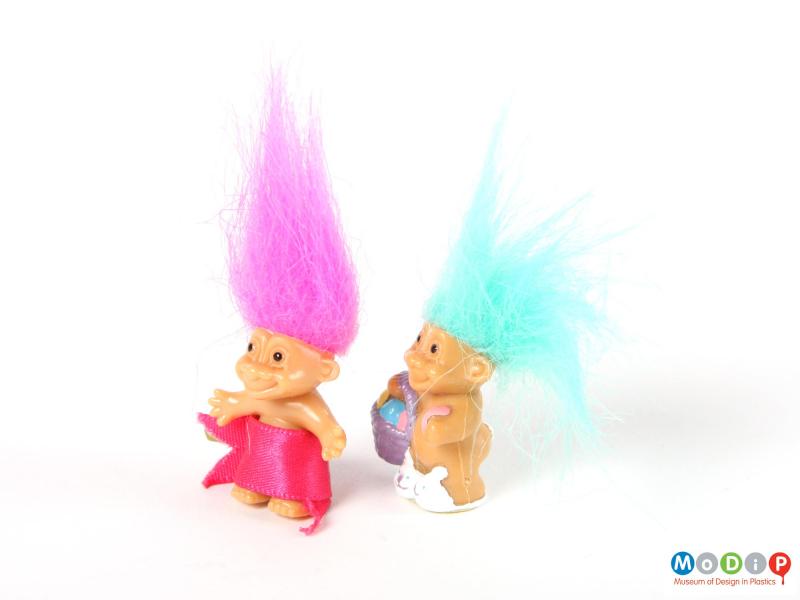 Side view of 2 trolls showing the rounded tummies.