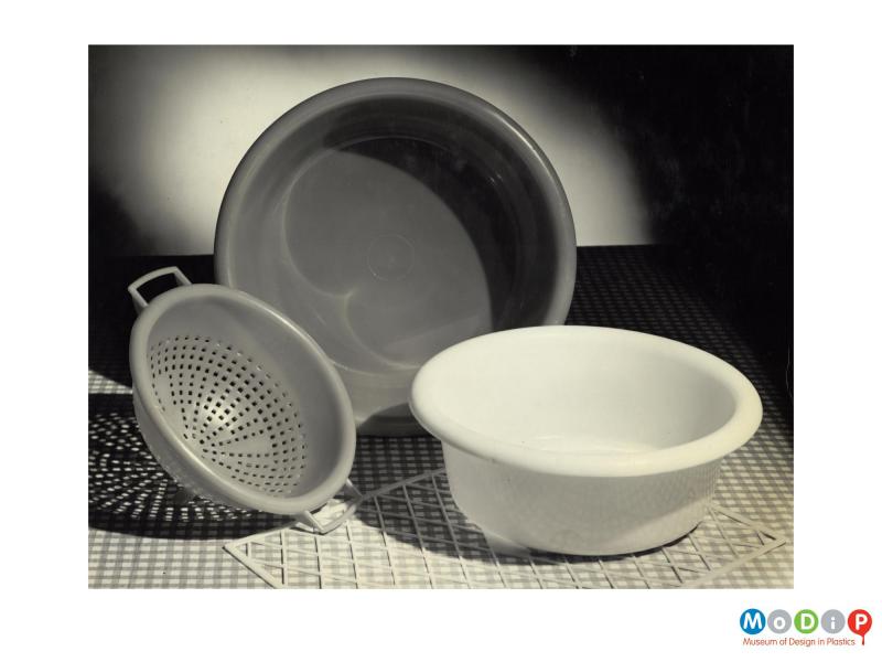 Scanned image showing 2 washing up bowls and a colander.