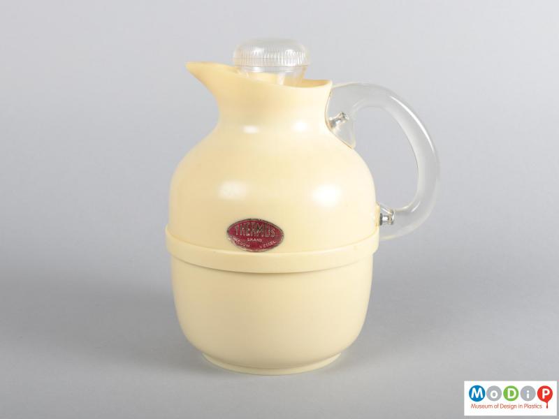 Side view of a jug showing the handle and adhesive label.