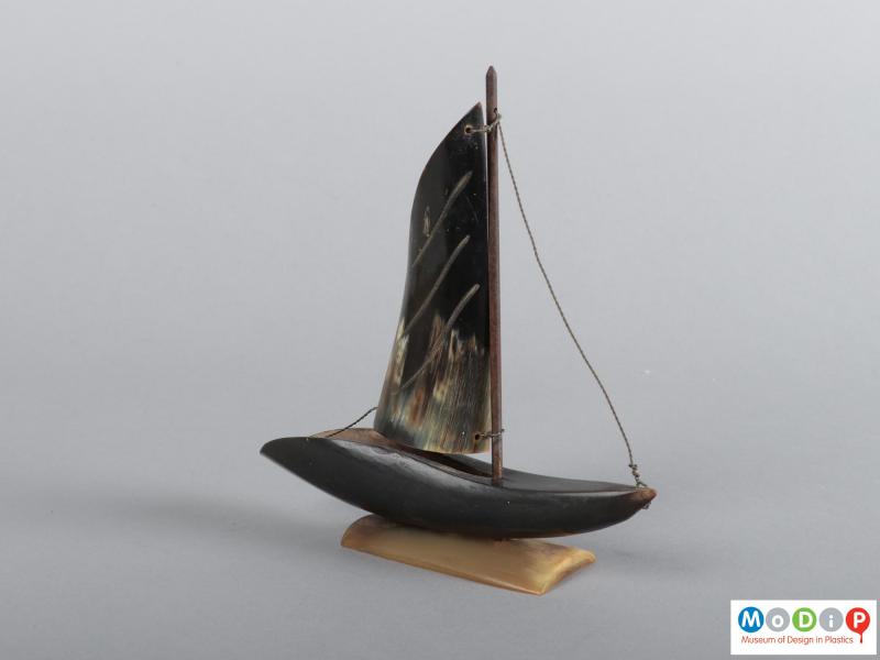 Side view of a horn boat ornament showing the metal rigging.