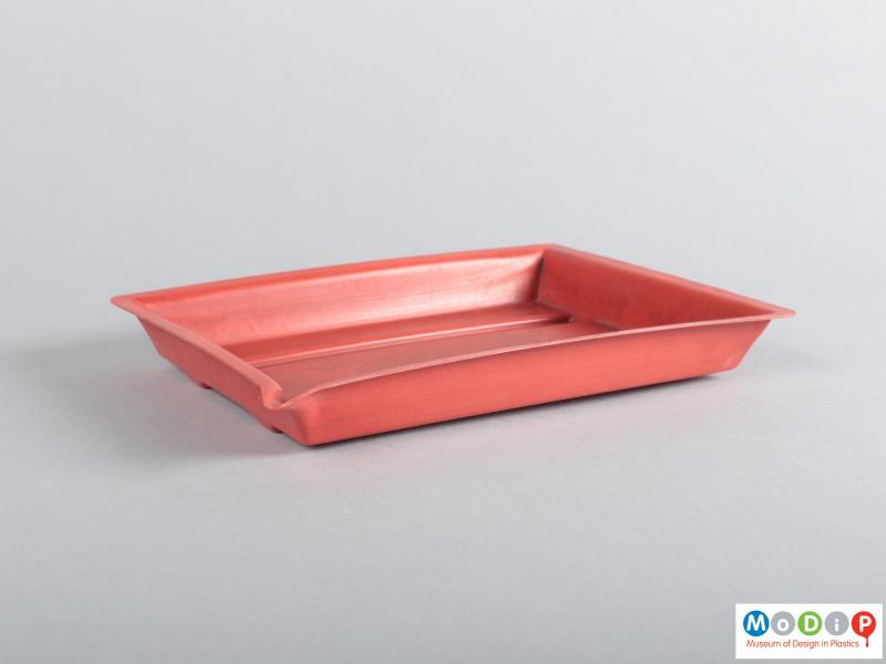 Side view of a developing tray showing the pouring spout.