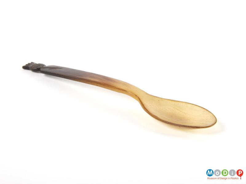 Side view of a spoon showing the straight handle and depth of the bowl.