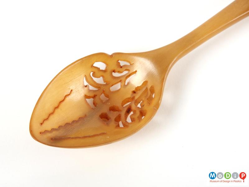 Close view of a spoon showing the carved bowl.