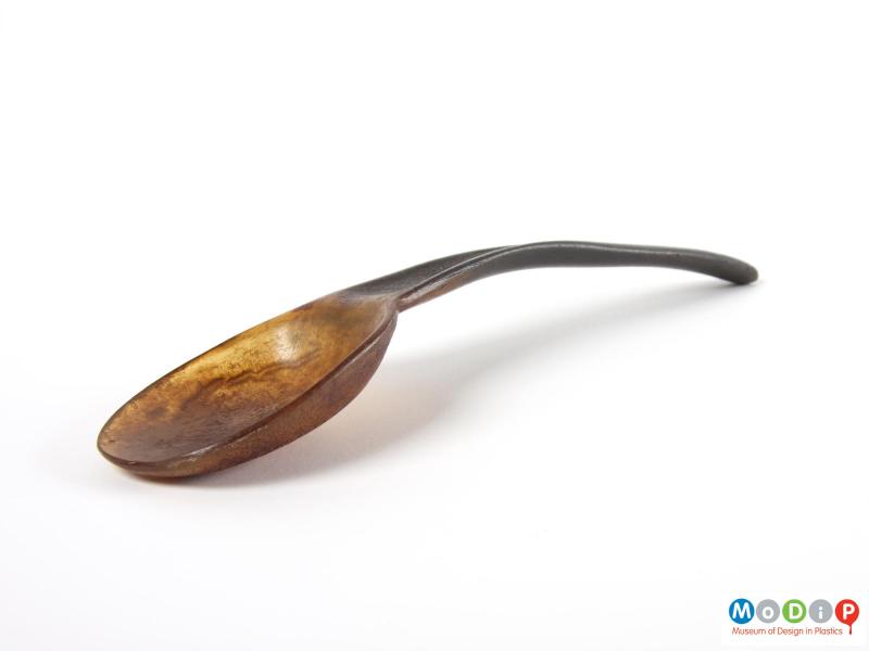 Side view of a spoon showing the curve in the handle and depth of the bowl.