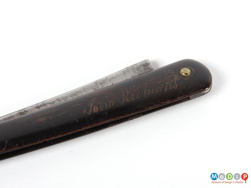 Close view of a penknife showing the engraved name.