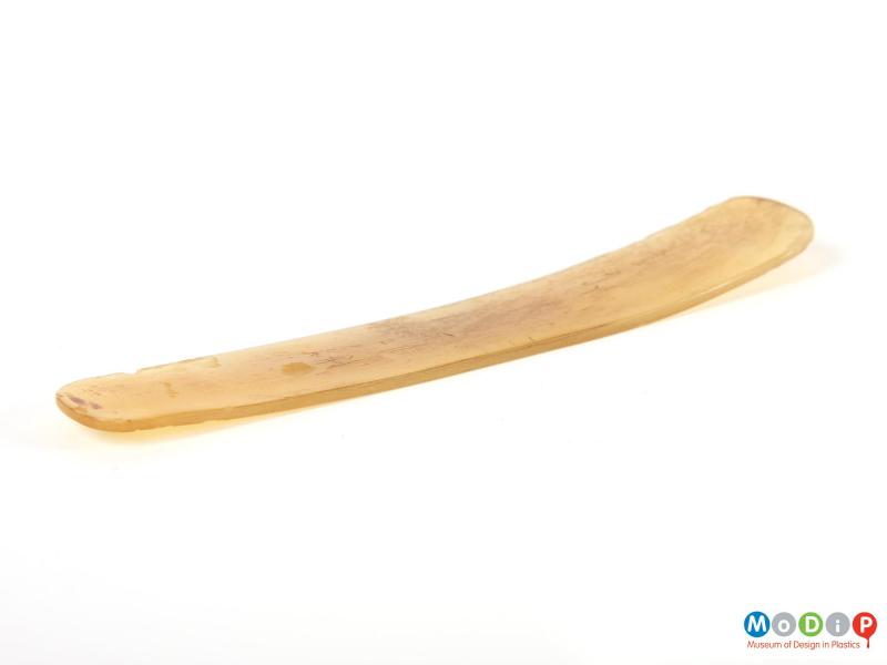 Side view of a spatula showing the curved shape.
