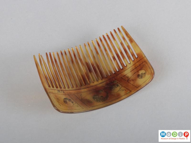 Underside view of a comb showing the heading and teeth.