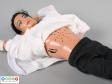Close view of a Michael Jackson doll showing the speaker and sound controls on the stomach.