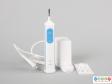 Front view of an electric toothbrush showing the body and charging unit.