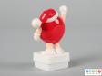 Side view of a red M&M figure showing the plain back.