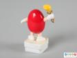 Side view of a red M&M figure showing the plain back.
