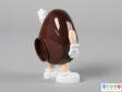 Side view of a brown M&M figure showing one hand held down by thr figure's side.