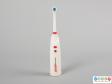 Front view of a toothbrush showing the round head and control buttons.