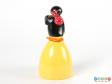 Rear view of a Pingu sweet container showing the penguin holding a stick and knotted handkerchief over its shoulder.