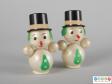 Front view of a pair of snowman showing their top hats and facial features.