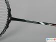 Close view of a badminton racket showing the shaft.