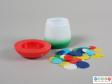 Side view of a set of tiddlywinks showing the container and all the discs.