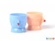 Front view of the blue egg cup standing in front of the pink egg cup.