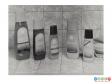 Scanned image showing 5 shmapoo and conditioner bottles in a bathroom setting.