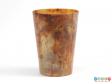 Side view of a beaker showing the marbled material.