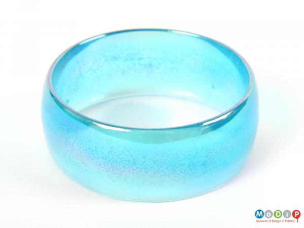 Top view of a blue bangle showing the curved edge.