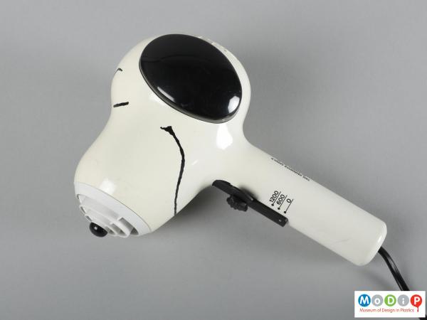 Side view of a hairdryer showing the printed and moulded features of the dog.