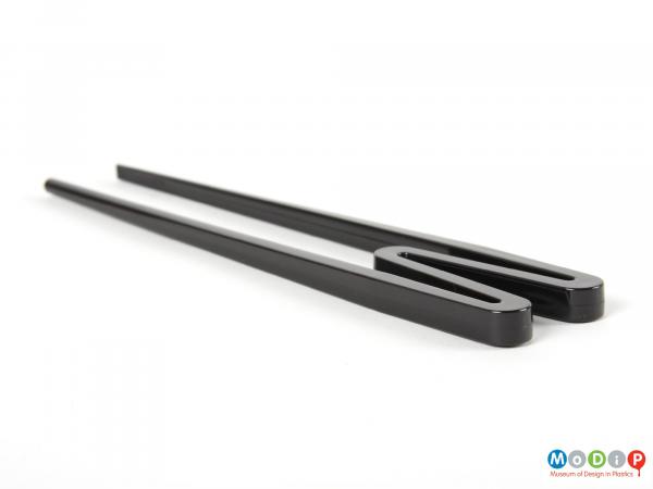 Side view of a set of chopsticks showing M shape.