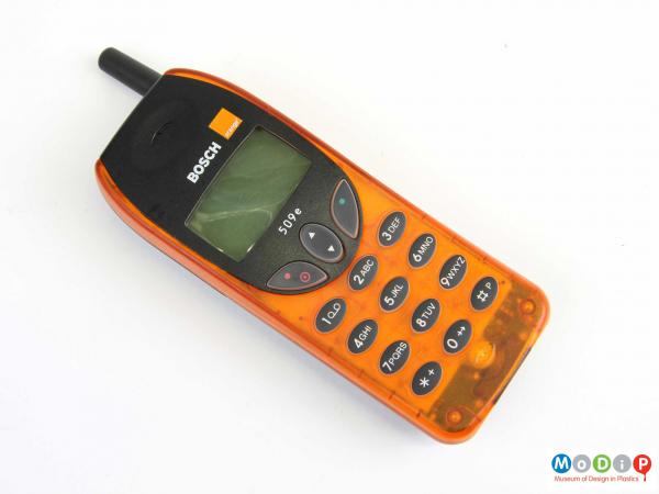 Front view of a mobile phone showing the translucent orange front cover.