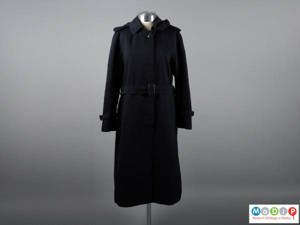 Front view of a coat showing the belted waist and full length.