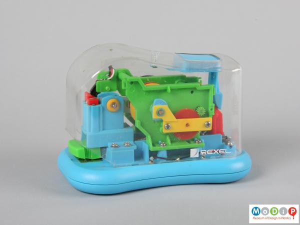 Side view of a Staple Wizard showing the curved, clear cover and multi-coloured workings.