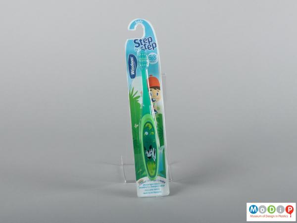 Front view of a pair of packaged toothbrushes showing the handles and bristles.
