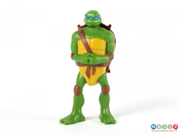 Front view of a Turtle figure showing the arms held at the front with clenched fists.