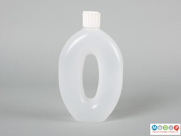 Side view of Runaid bottle showing the whole in the centre forming a handle.