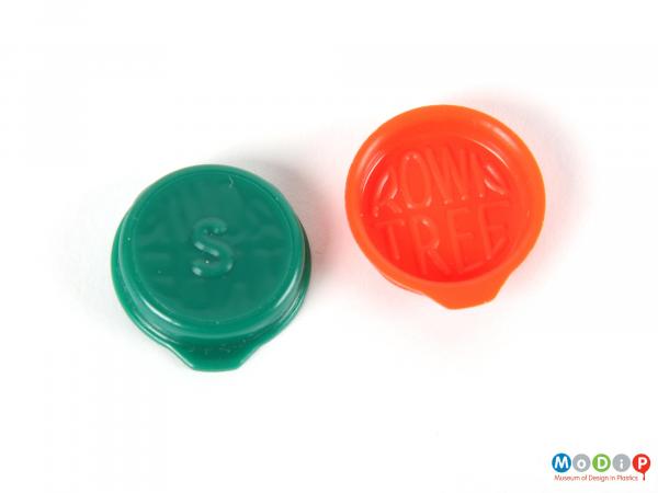 Top view of two Smarties lids showing the moulded inscriptions.
