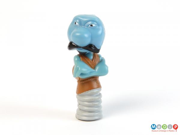 Front view of a pencil topper showing the character's folded arms.