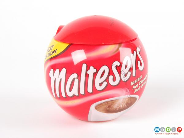 Side view of a Malteser jar showing the spherical shape and red lid.