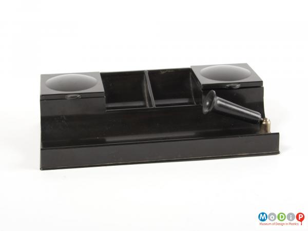 Front view of a desk tidy showing the moveable pen holder.