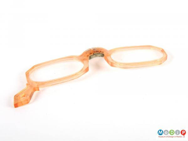 Front view of a pair of glasses showing the hinged nose piece.