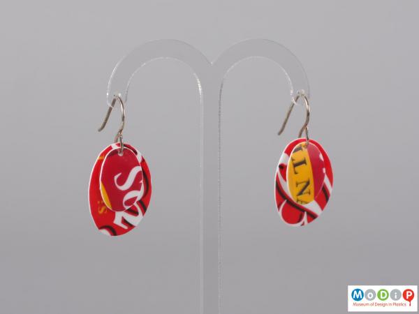 Front view of a pair of Sour Cream pot earrings showing the two layers of material hanging on the fixings.